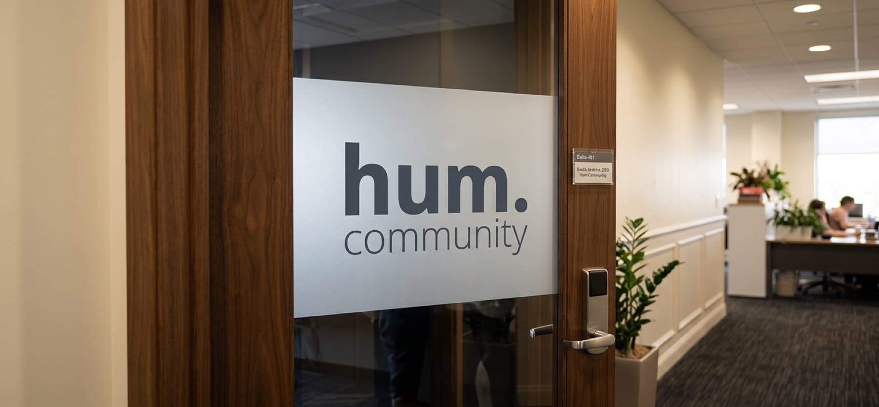 The hum.community office — frosted glass door with the hum.community logo